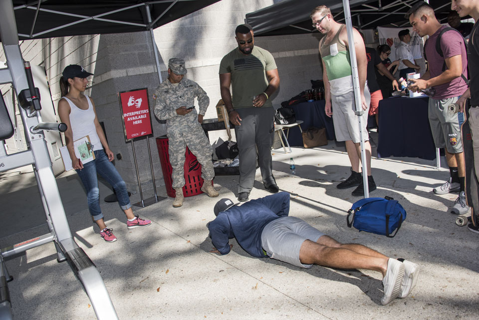 Veterans challenge a student to a pushup contest.