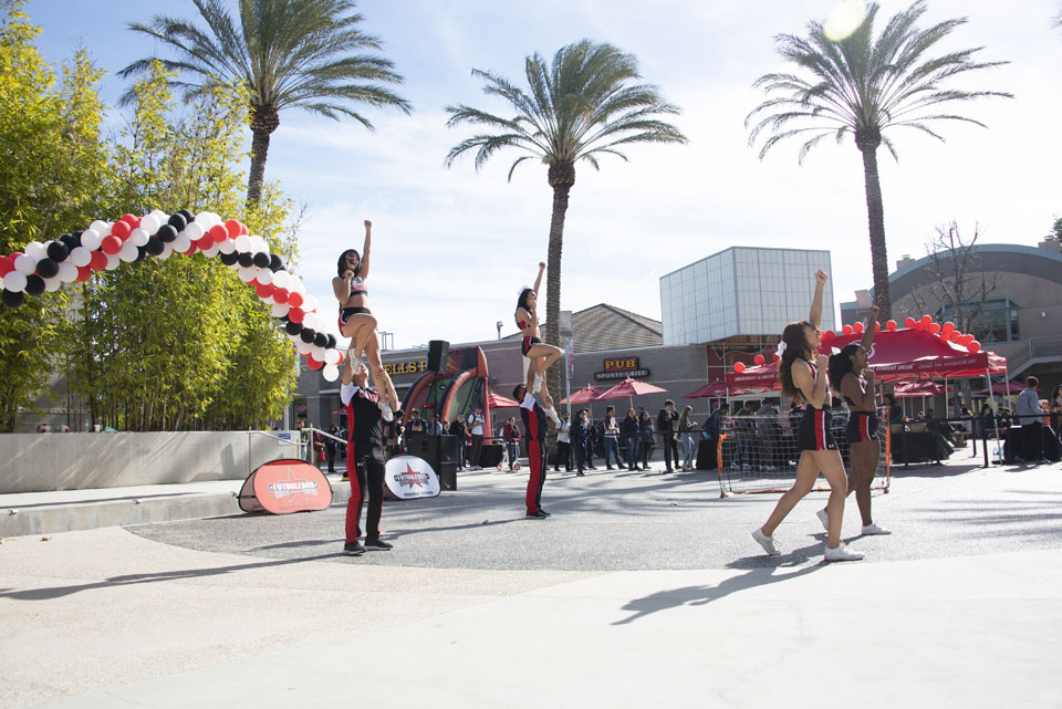 CSUN cheerleaders performing a stunt and cheer routine at Plaza del Sol.