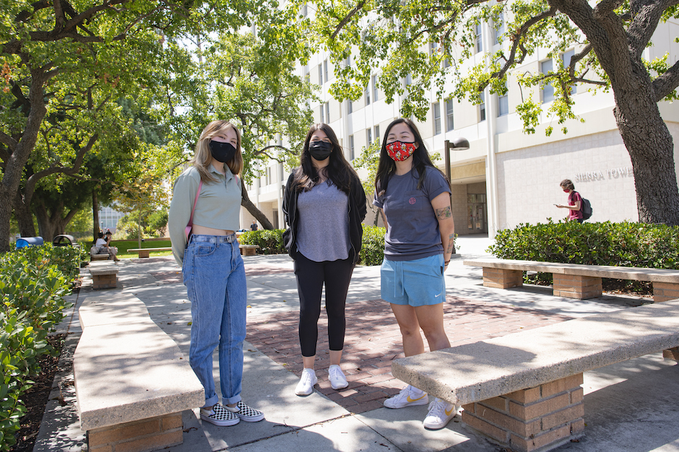 Three female students wearing masks.