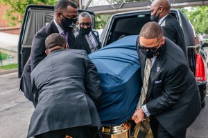 A group of men in Minnesota lift George Floyd's casket from a hearse.