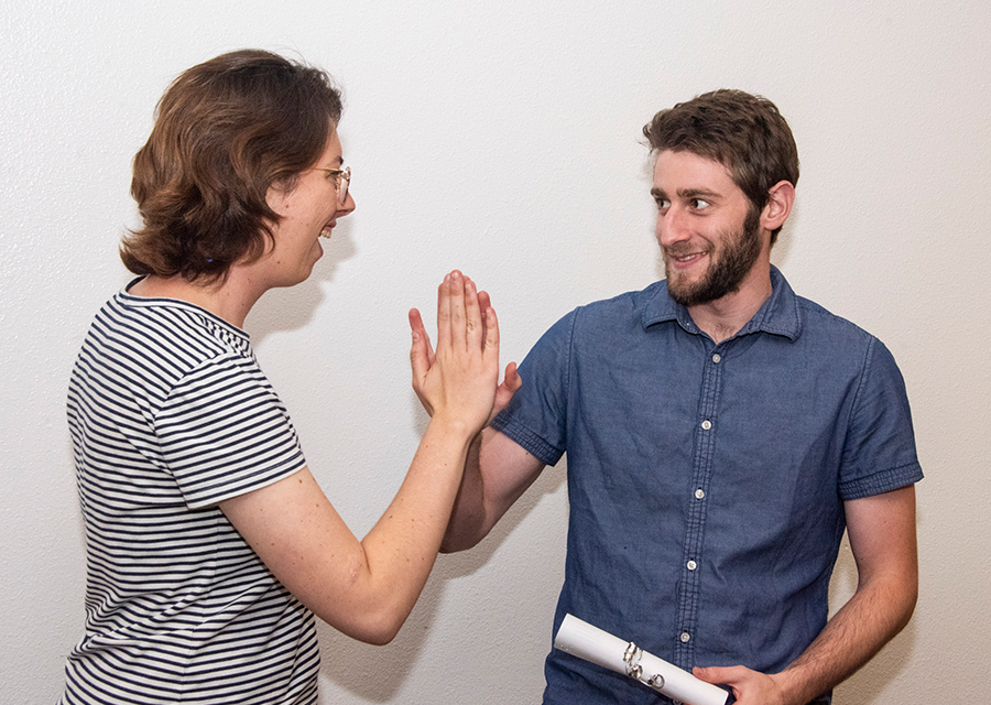 Mehrnaz Siavoshi and Alexander Alon of The Crystal Gems high-five as they receive their awards for Best Insights during the awards ceremony of DataJam 2019 at the University Student Union on Oct. 18.