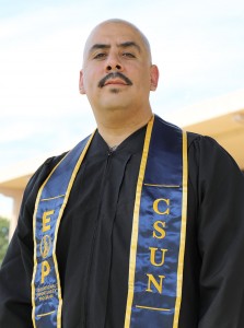 EOP Resilient Scholars Program alumnus Albert Martinez stands near the University Library.