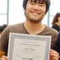 EOP Resilient Scholars Program senior Tony Tong poses with a certificate of academic achievement at an EOP awards banquet in the University Student Union.