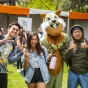 Students posing with person in squirrel costume.
