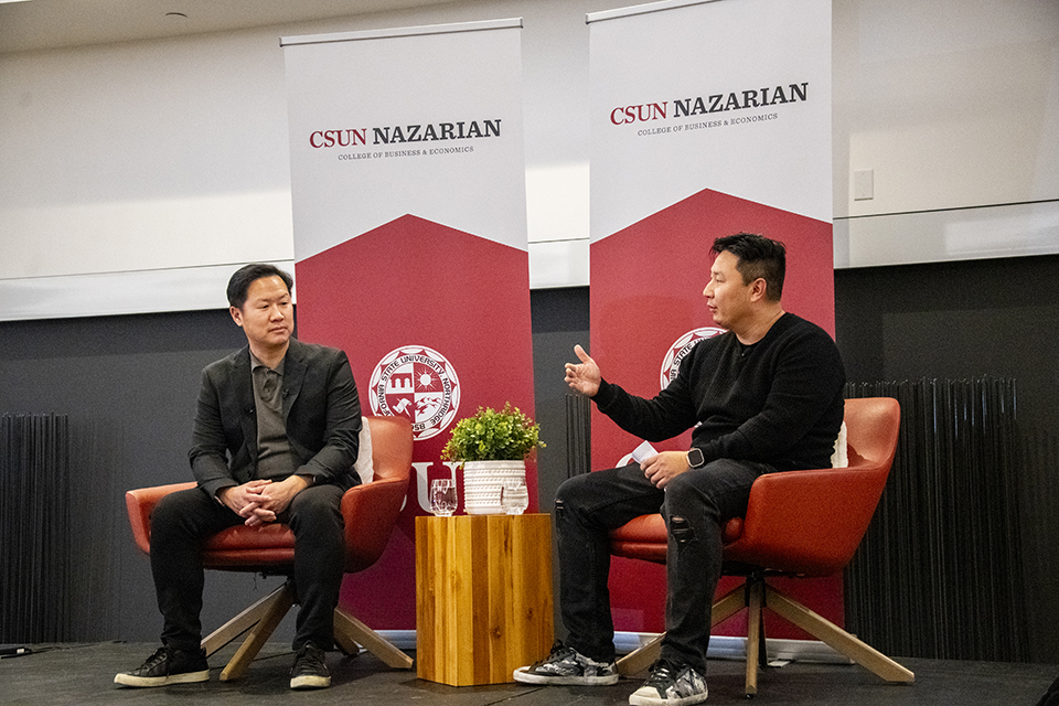 Eric Chan and Jang Lee sit on stage for a discussion.