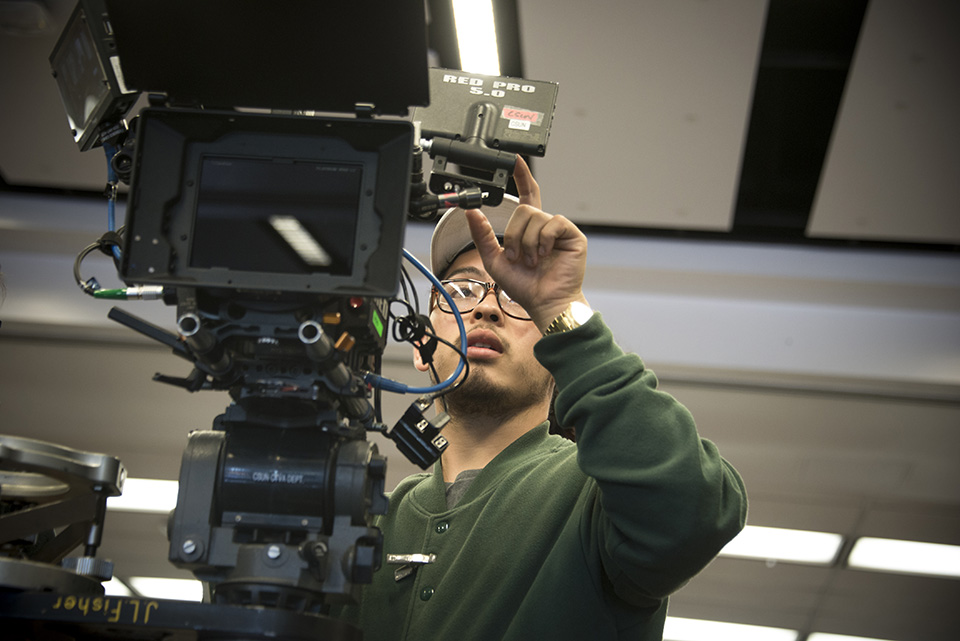 A CSUN Cinema and Television Arts student films a scene inside the CSUN Library. CSUN was recently ranked at No. 21 on The Wrap's top 50 film schools list.