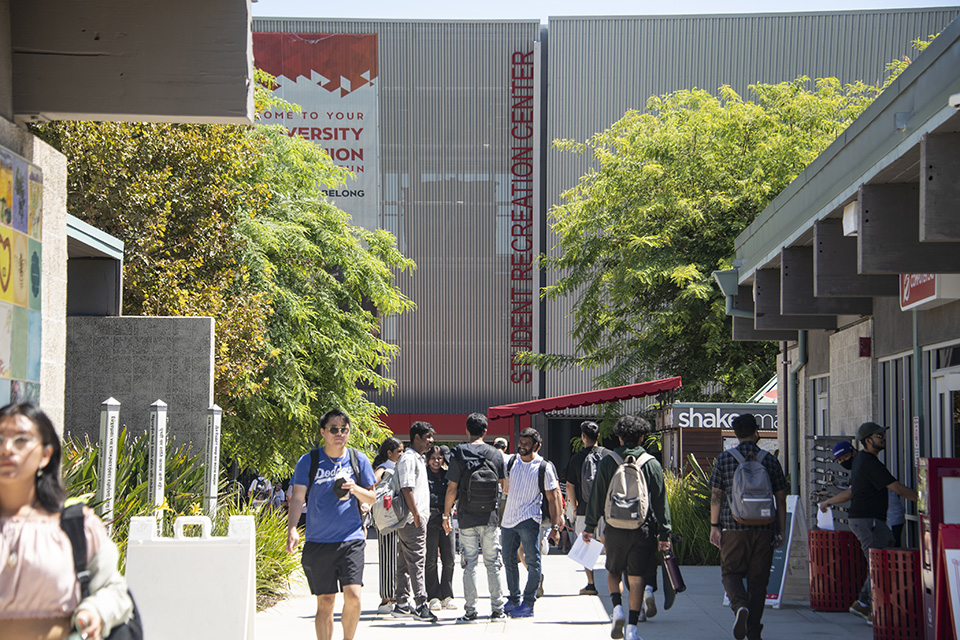Students walking along pathway leading to the Student Recreation Center