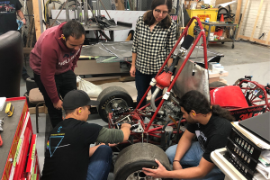 Mechanical engineering students in the Formula SAE Internal Combustion Vehicle team construct the race car in a CSUN lab.