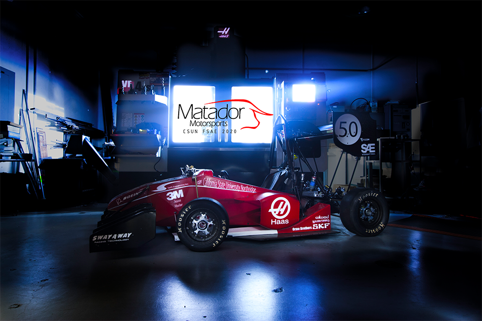 The Formula SAE Internal Combustion Vehicle, a red race car, photographed inside the lab.