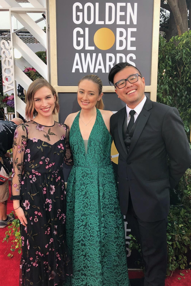 Allison Bird, Amanda Derzy and Robert Ahn pose on the red carpet before the 2018 Golden Globes.