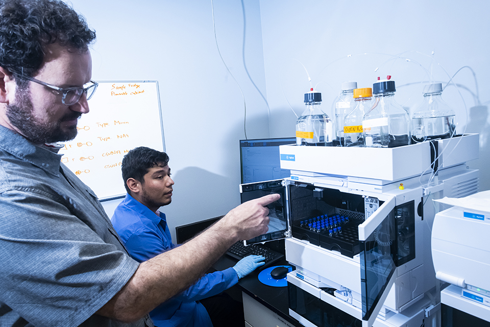 CSUN Professor Gilberto Flores and graduate student Luis Duran work with High-Performance Liquid Chromatography system (HPLC), which arrived at CSUN in May. 