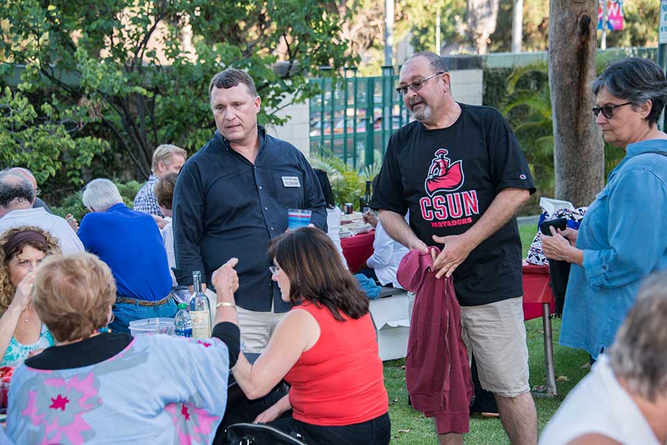 Assistant VP for Alumni Relations Gray Mounger (center) enjoys the festivities along with the CSUN alumni. Photo by Nestor Garcia.