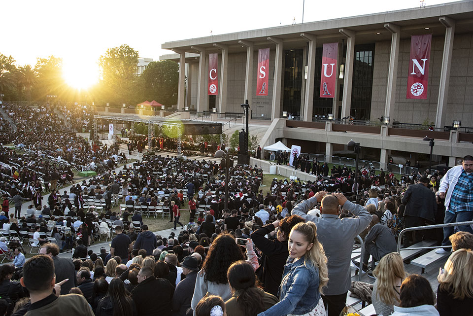 An aerial view of the Oviatt Lawn, which is packed for CSUN commencement as the sun goes down.
