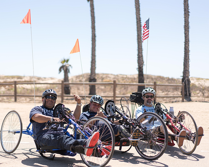 Three veterans riding hand cycles.