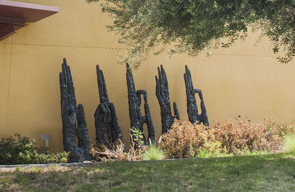 The sculpture of "Heavenly Hands," which are porcelain glazed in black, stand tall in front of CSUN's Art and Design Center.