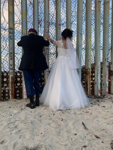 Repatriated U.S. Army veteran Hector with his deported bride, Yolanda Palacios of Madres Deportadas, looking into the United States on their wedding day. Photo by Joseph Silva.