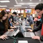 Students focus as they choose what cap and gown package to order with HerffJones