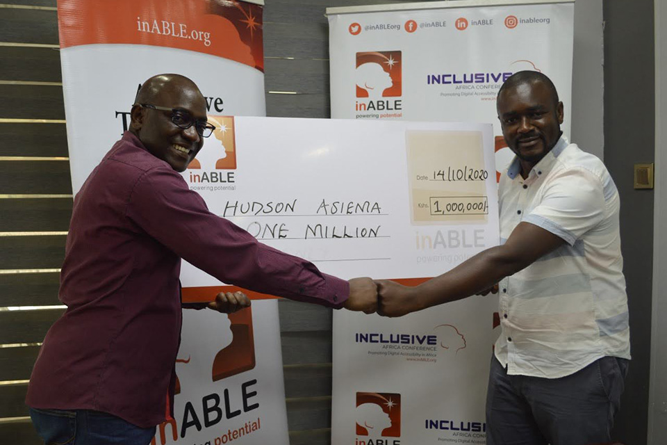 Hudson Asiema accepting the Digital Accessibility Innovation Award and prize money awarded to him in 2020 by the first Inclusive Africa Conference.