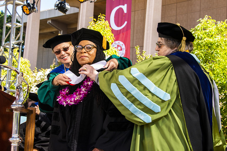 CSUN President Dianne F. Harrison (left) and Interim Provost Stella Theodoulou (right) present Susan Burton, an advocate for incarcerated women and at-risk youth, with an honorary Doctor of Humane Letters.