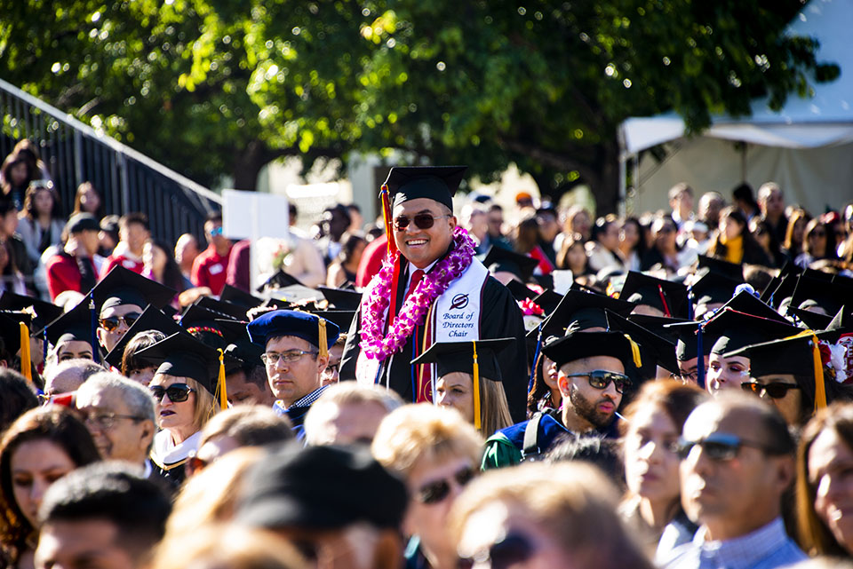 Bhernard Tila stands tall as he is recognized at CSUN commencement.
