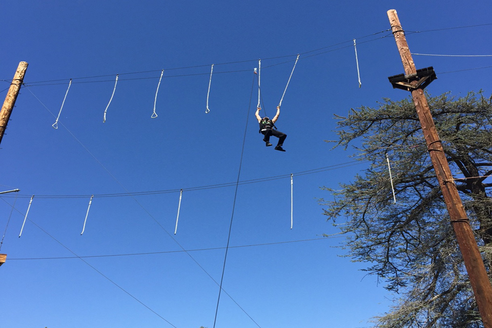 Swinging on the ropes course.