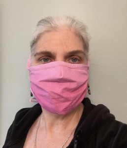 A woman wears a homemade surgical mask.