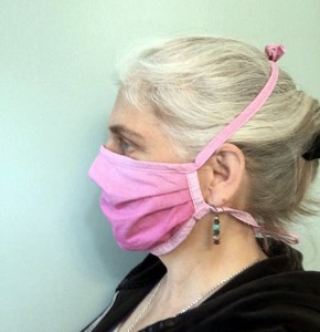A woman wears a homemade surgical mask.