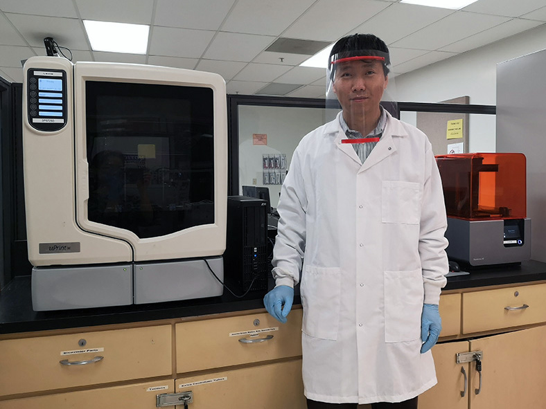 Bingbing Li, CSUN assistant professor of Manufacturing Systems Engineering, wears a face shield created in his lab.