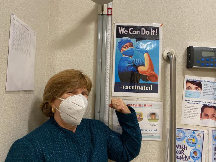 CSUN alumna Terri Stratton, ’78 (Health Science), MPH ’85 (Public Health), the chief executive officer of El Dorado Community Health Centers, poses with a COVID-19 vaccine po