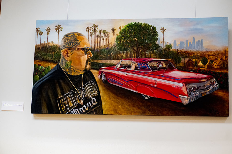 Painting of man wearing sunglasses looking at large red car.