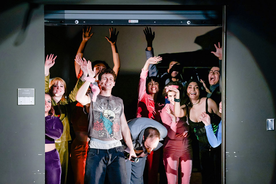 Actors from the CSUN Department of Theatre's spring 2023 performance of "Lysistrata" take a curtain call from the Experimental Theatre's storage closet, which became part of the set to create the illusion of a TV studio.