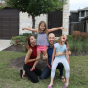 CSUN alumni Sheena McFeely and her husband, Manny Johnson, in front of their home in Texas, with their daughters, Ivy and Shaylee.