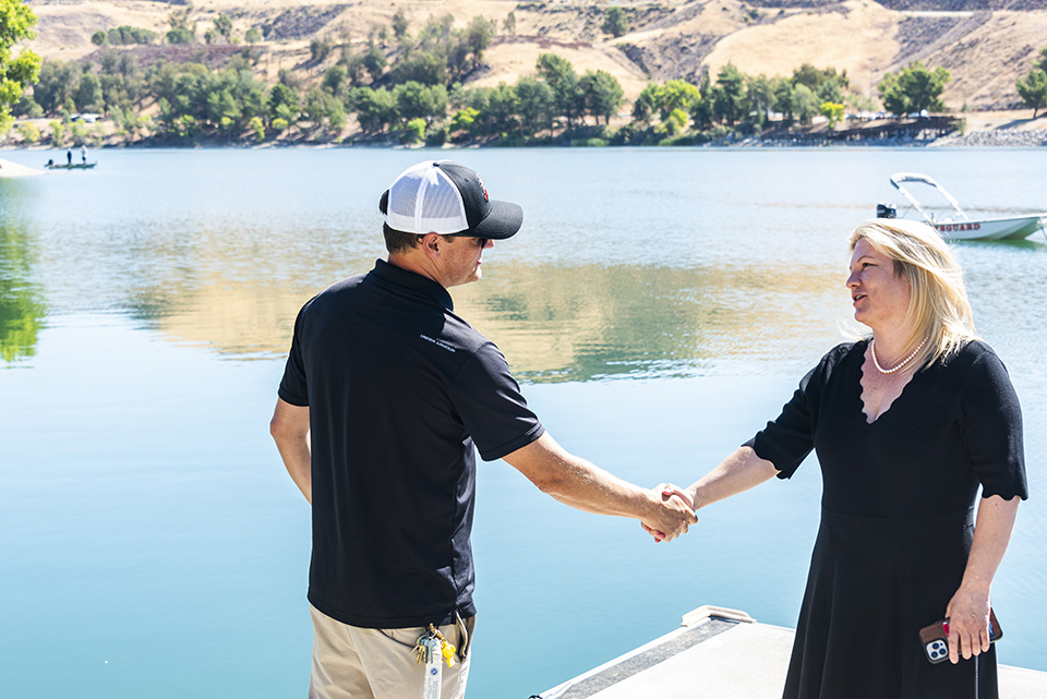 Nathan Martin and Erika D. Beck shake hands on deck of Castaic Lake