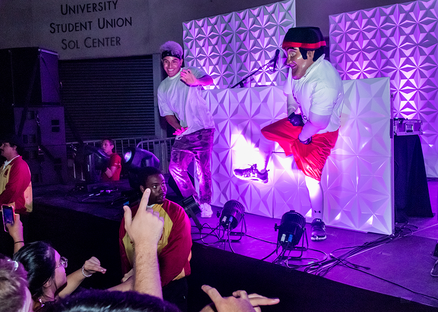 DJ DŸLN dances onstage with Matty the Matador during Matador Nights on Sept. 13 at the University Student Union.