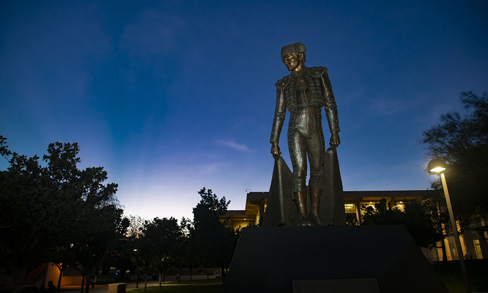 Matador statue against dark sky