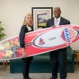 President and Athletic Director with surfboard.