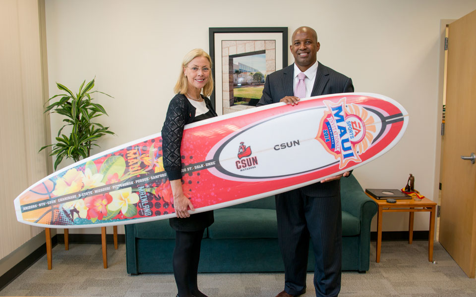President and Athletic Director with surfboard.