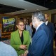 Los Angeles Mayor Karen Bass shakes hands with a man in a blue suit as she walks through the Orchard Conference Center Lobby.