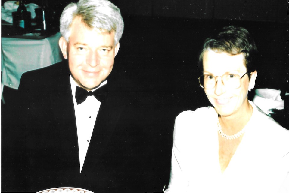 Michael and Ann Patterson wearing formal attire and smiling at the camera. 
