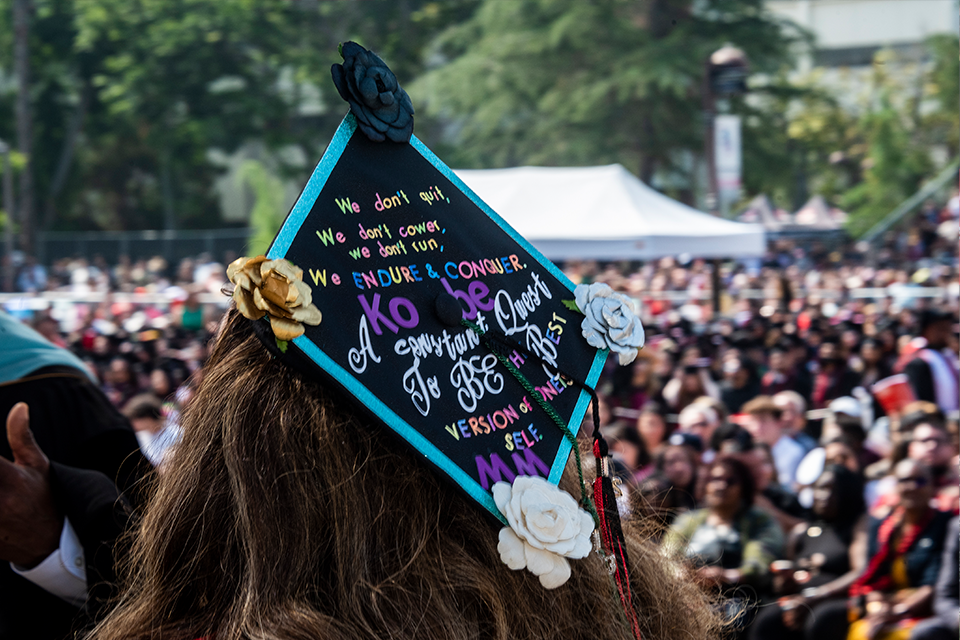 Mortarboard decorated with flowers and inspirational quote.