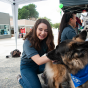 A CSUN student meets one of Love on a Leash's furry friends at the 