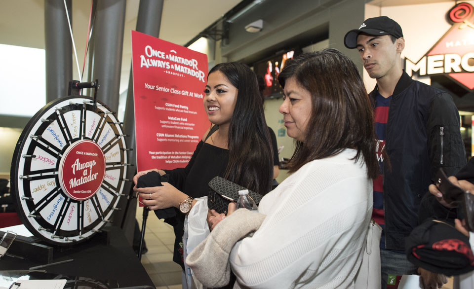 Students spin a wheel to win a prize.
