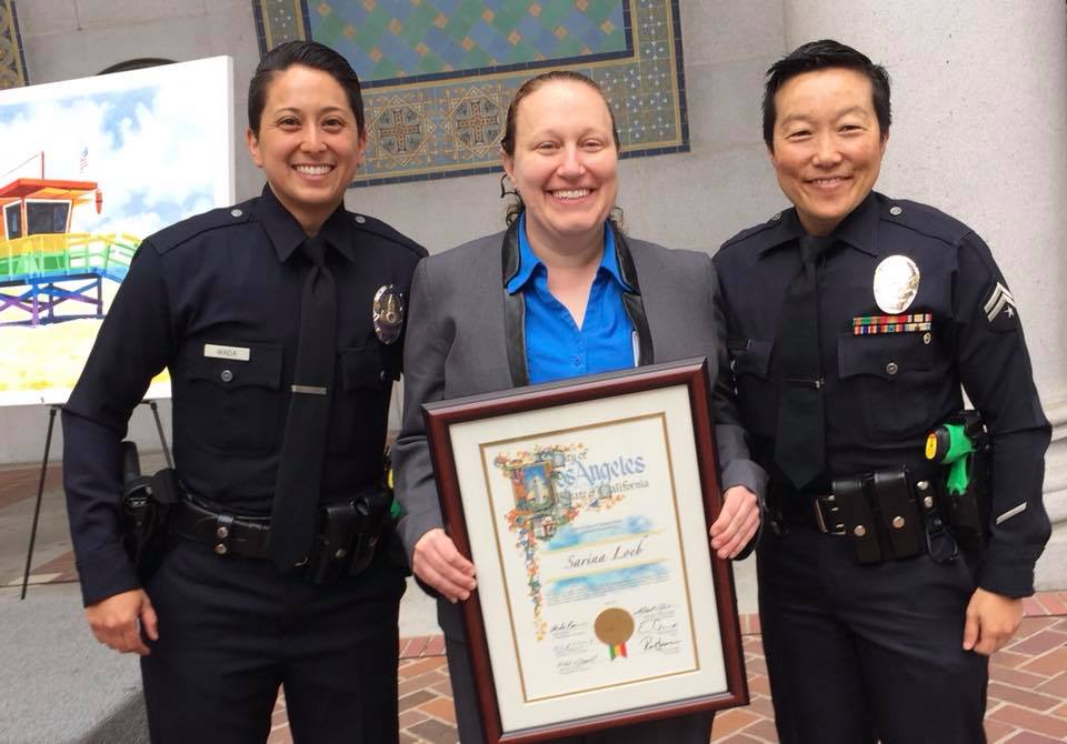 Sarina Loeb, Pride Center coordinator standing next to LAPD LGBTQ Liaisons at her recognition in May.