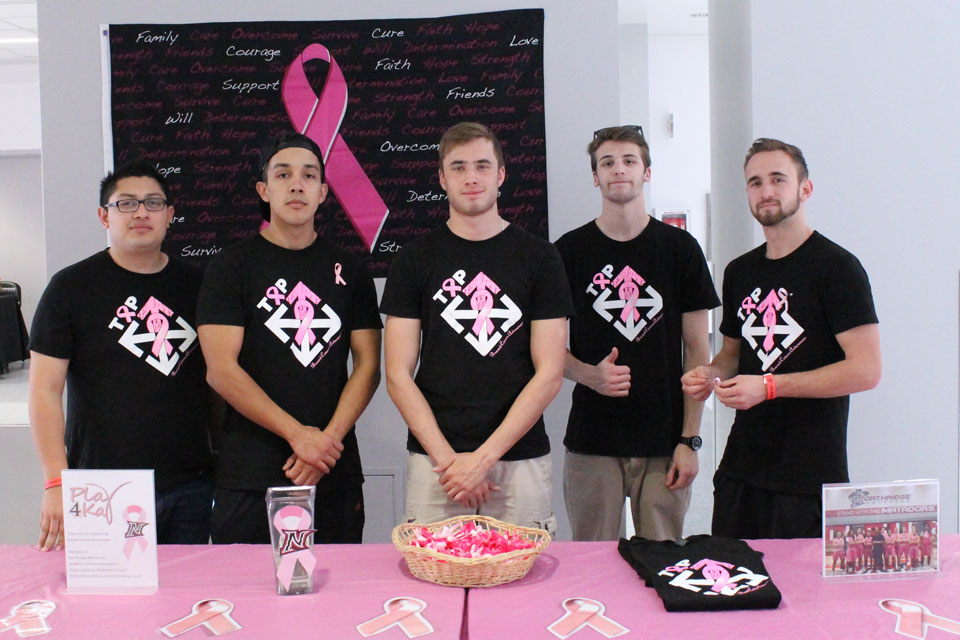 Fraternity members at pink table.
