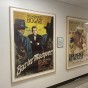 An image captured of two movie posters. One is for 'Bas les Masques,' a Humphrey Bogart Film and one is a poster for 'Une Place Au Soleil,' an Elizabeth Taylor film.