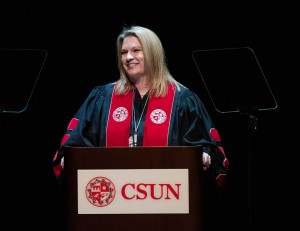 CSUN President Erika D. Beck stands at a podium, with a CSUN sign and seal in front, as she speaks during the investure ceremony at The Soraya on March 14, 2022.