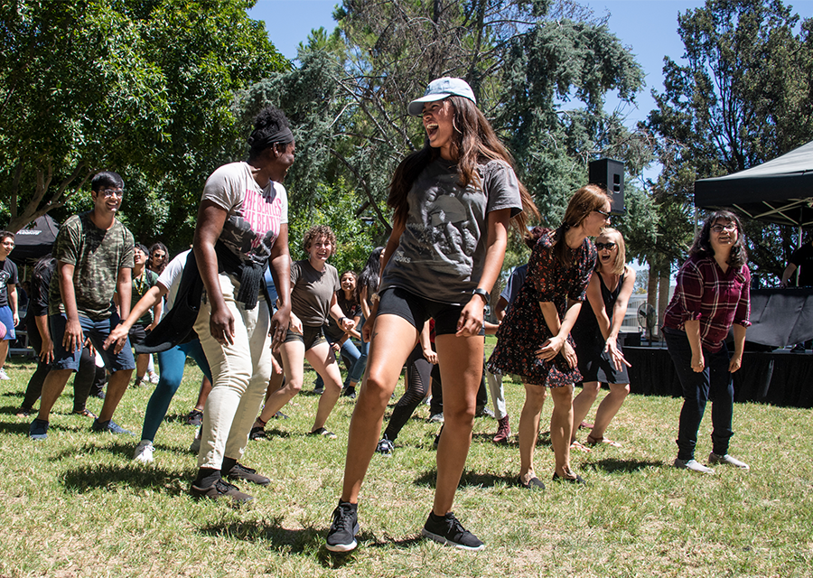 Students dance together to the thumping music on the Bayramian Hall Lawn during the President's Picnic on Aug. 29.
