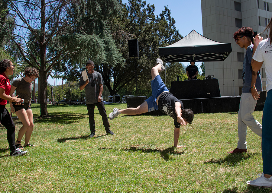 Students show off their moves to the beats of the DJ during the President's Picnic on the Bayramian Hall Lawn on Aug. 29.