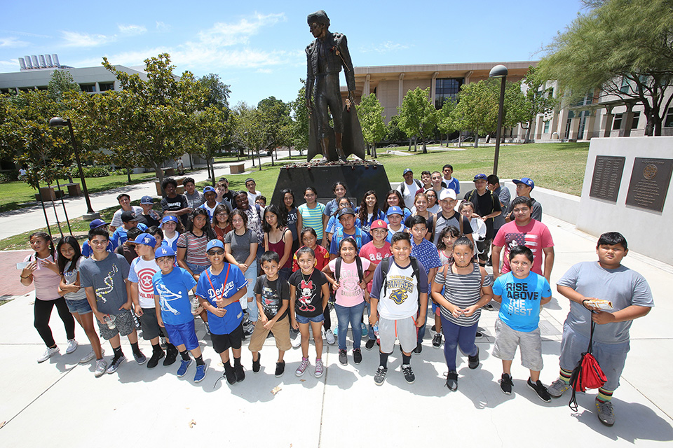 Young people in front of CSUN's Matador Statue.