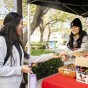 Student hands snack to other student at Welcome Week